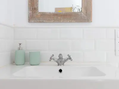 a bathroom sink with a mirror and aaucet at Casa Cosi - Eixample 4 in Barcelona