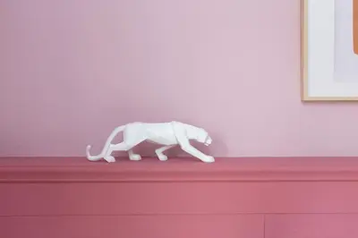 a white elephant statue sitting on top of a dresser at Casa Cosi - Eixample 5 in Barcelona