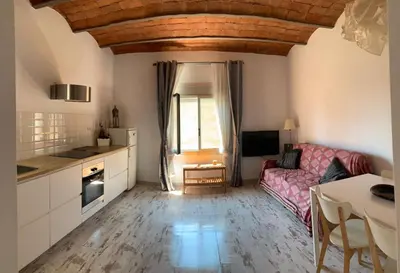 a kitchen and living room with a couch and a table at BlauMasnou One step to the beach! in Masnou
