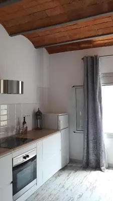 a kitchen with white cabinets and a window at BlauMasnou One step to the beach! in Masnou