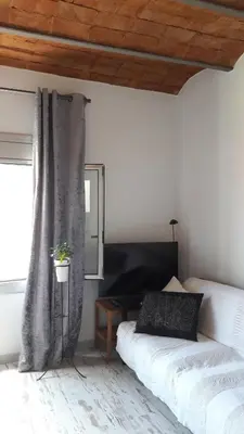 a bedroom with two beds and a window with a potted plant at BlauMasnou One step to the beach! in Masnou