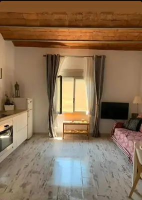 a living room with a bed and a window at BlauMasnou One step to the beach! in Masnou