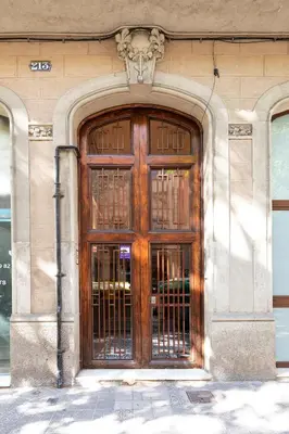 a large wooden door on the side of a building at Chic Apartments Barcelona in Barcelona