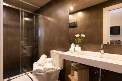a bathroom with a toilet and a sink and a shower at Chic Apartments Barcelona in Barcelona