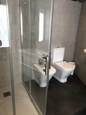 a bathroom with a toilet and a glass shower at Discover Sitges Center&Beach, a un minuto del mar in Sitges