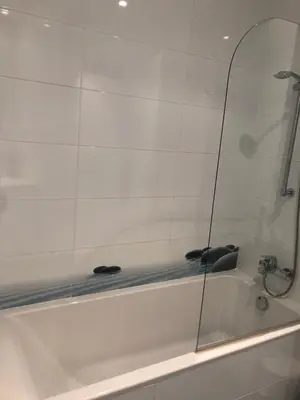 a white bath tub with a glass window on it at Discover Sitges Center&Beach, a un minuto del mar in Sitges