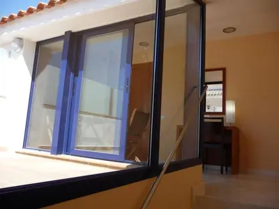 a room with a window with a chair in it at Hotel Verti in Corró de Vall