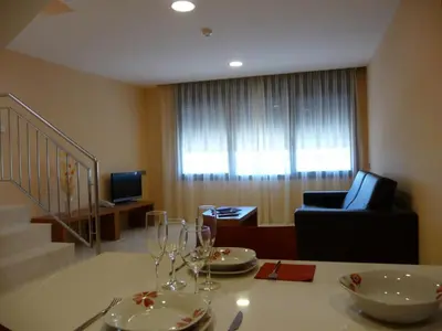 a room with a table with glasses and a chair at Hotel Verti in Corró de Vall
