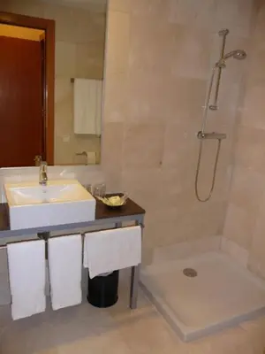 a bathroom with a sink and a shower at Hotel Verti in Corró de Vall
