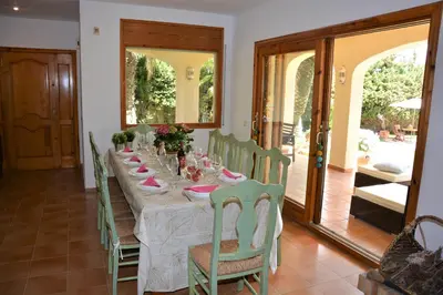 a dining room with a long table and chairs at Villa Sitges Colibri at 10 min Walk Beaches - Center City Amaizing Garden Pool XXL Private Tenis Piste in Vilanova i la Geltrú
