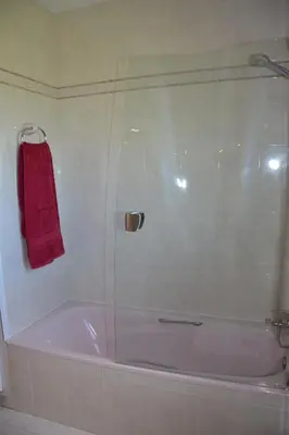 a bathroom with a shower with a red towel at Villa Sitges Colibri at 10 min Walk Beaches - Center City Amaizing Garden Pool XXL Private Tenis Piste in Vilanova i la Geltrú