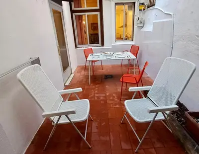 a room with chairs and a table and a table and chairs at Clot MiraBarna Apartments in Barcelona