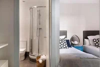 a bathroom with a shower and a bed and a toilet at C211 Barcelona - Simaba Group in Barcelona