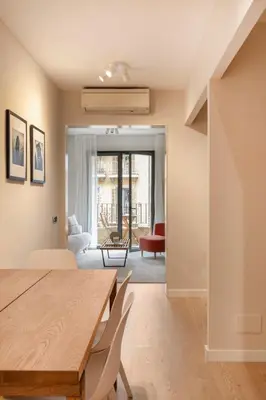a dining room with a table and chairs and a living room at C211 Barcelona - Simaba Group in Barcelona