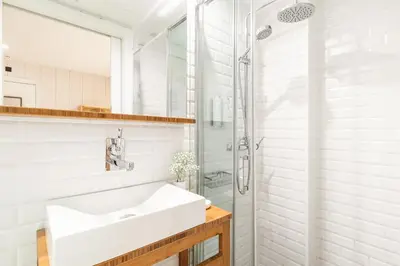 a white bathroom with a sink and a shower at Casa Bella Gracia by Aspasios in Barcelona