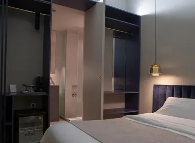 a bedroom with a bed and a flat screen tv at BUHO Boutique Rooms in Barcelona