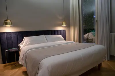 a bedroom with a bed and a glass wall at BUHO Boutique Rooms in Barcelona