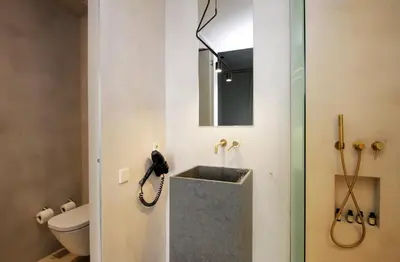 a phone is hanging on a wall in a bathroom at BUHO Boutique Rooms in Barcelona