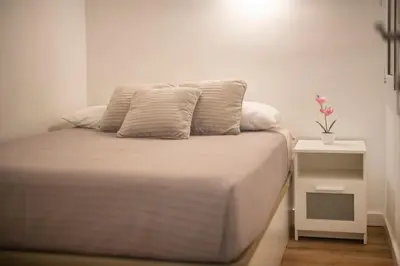 a bed with two pillows on it in a room at Apartamento a 100 metros de la playa in Pineda de Mar