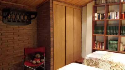 a stuffed bear sitting in a chair in a room at agradable y familiar in Premiá de Mar