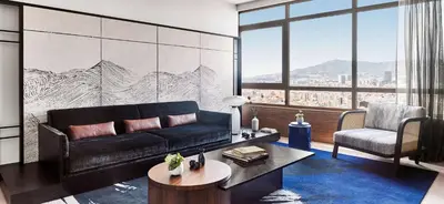 a living room with a couch and a table at Nobu Hotel Barcelona in Barcelona