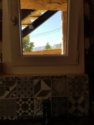 a bathroom window with a view of the mountains at Apartament Vall de Montserrat in Castellbell i Vilar