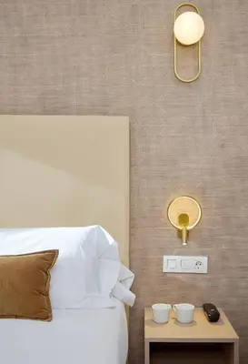 a bedroom with a bed and a table with two cups on it at Hostal Centric in Barcelona
