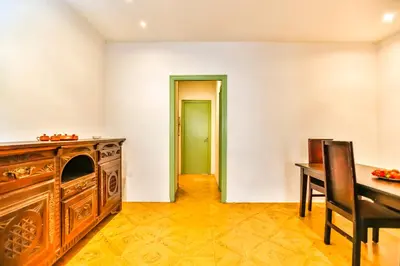 a dining room with a table and a wooden cabinet at Basic Platja in Barcelona
