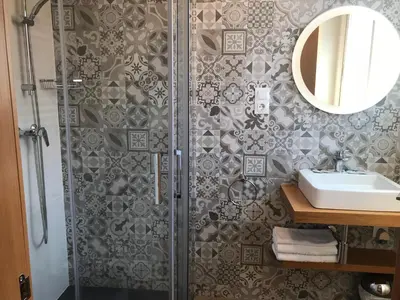 a bedroom with a desk and a television on the wall at Hostal La Romànica in Sabadell