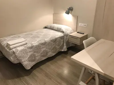 a bathroom with a sink and a mirror at Hostal La Romànica in Sabadell