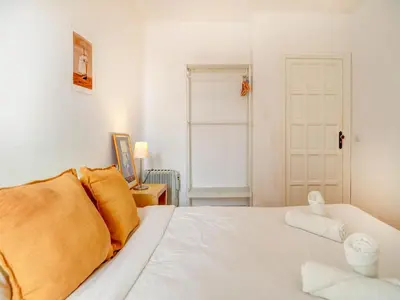 a living room with a white table with a tv at Gladiator Apartment by Hello Homes Sitges in Sitges