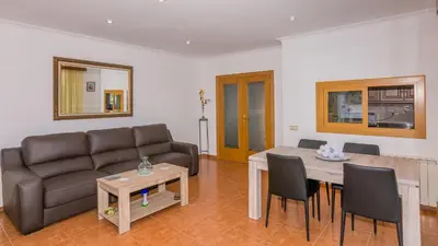 a living room with a couch and a table at HomeHolidaysRentals Aube in Sant Cebrià de Vallalta