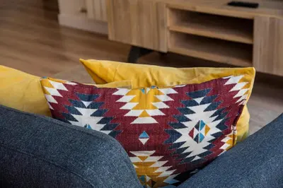 a couch with two pillows on top of it at Petit Luxe Tobella Baixos in Terrassa