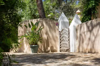 a fence with a potted plant in front of it at Casa Los Arcos at Masia Nur Sitges, Adults only in Canyelles