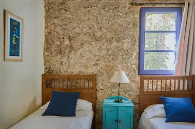 a bedroom with two beds and a window at Casa Marqués at Masia Nur Sitges, Adults only in Canyelles
