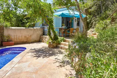 a house with a swimming pool in a yard at Casa Granada at Masia Nur Sitges, with private pool and adults only in Canyelles