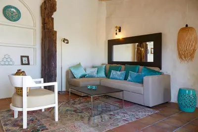 a living room with a couch and a mirror at Casa La Premsa at Masia Nur Sitges, Adults only in Canyelles