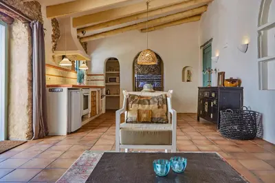 a kitchen with a table and chairs in a room at Casa La Premsa at Masia Nur Sitges, Adults only in Canyelles