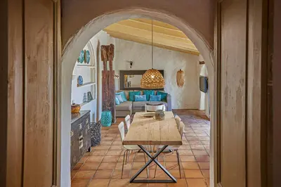 a living room with a table and a couch at Casa La Premsa at Masia Nur Sitges, Adults only in Canyelles