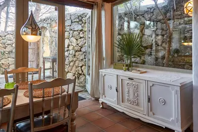 a dining room with a table and a window at Casa Jasmin at Masia Nur Sitges, Adults only in Canyelles