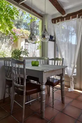 a dining room with a wooden table and chairs at Casa Jasmin at Masia Nur Sitges, Adults only in Canyelles