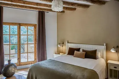 a bedroom with a bed and a large window at Villa Hermosa at Masia Nur Sitges, Adults only in Canyelles