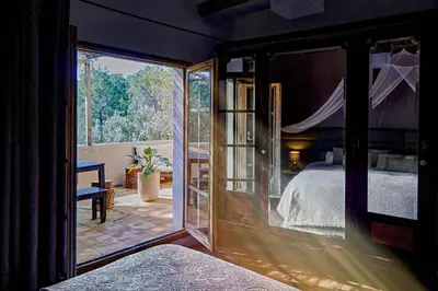 a bedroom with a bed and a large window at Villa Hermosa at Masia Nur Sitges, Adults only in Canyelles