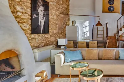 a living room with a couch and a fireplace at Casa Azul at Masia Nur Sitges, Adults only in Canyelles