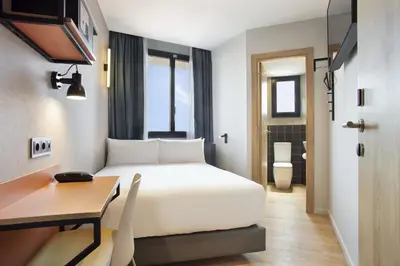 a hotel room with a bed and a desk at Hotel Brick Barcelona in Barcelona
