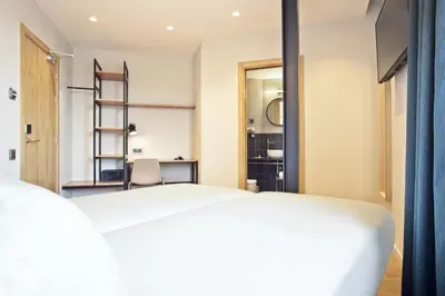 a bedroom with a bed and a mirror at Hotel Brick Barcelona in Barcelona