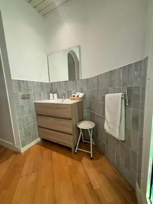 a bathroom with a sink and a mirror at Spacious & Comfortable flat in centric Eixample in Barcelona