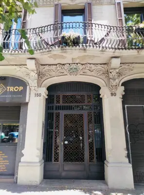 a building with a large door and a balcony at Spacious & Comfortable flat in centric Eixample in Barcelona