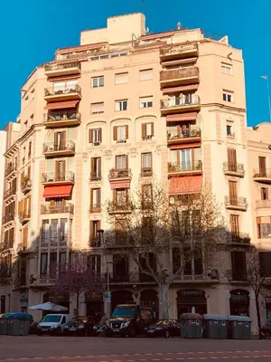 a tall building with cars parked in front of it at Spacious & Comfortable flat in centric Eixample in Barcelona
