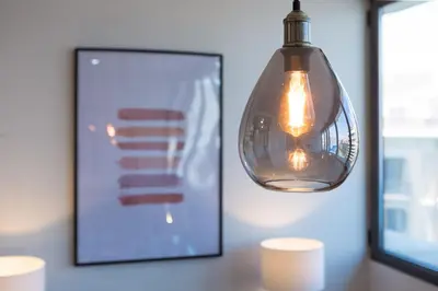 a light bulb hanging over a table with a picture at SibsBcn Downtown Penthouse in Barcelona